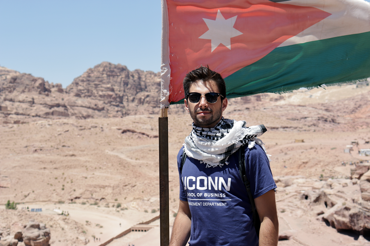 uconn student with jordan flag in dessert